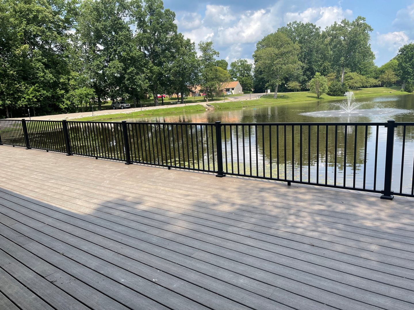 Park pond with fountain and wooden deck. Park pond with fountain and wooden deck.